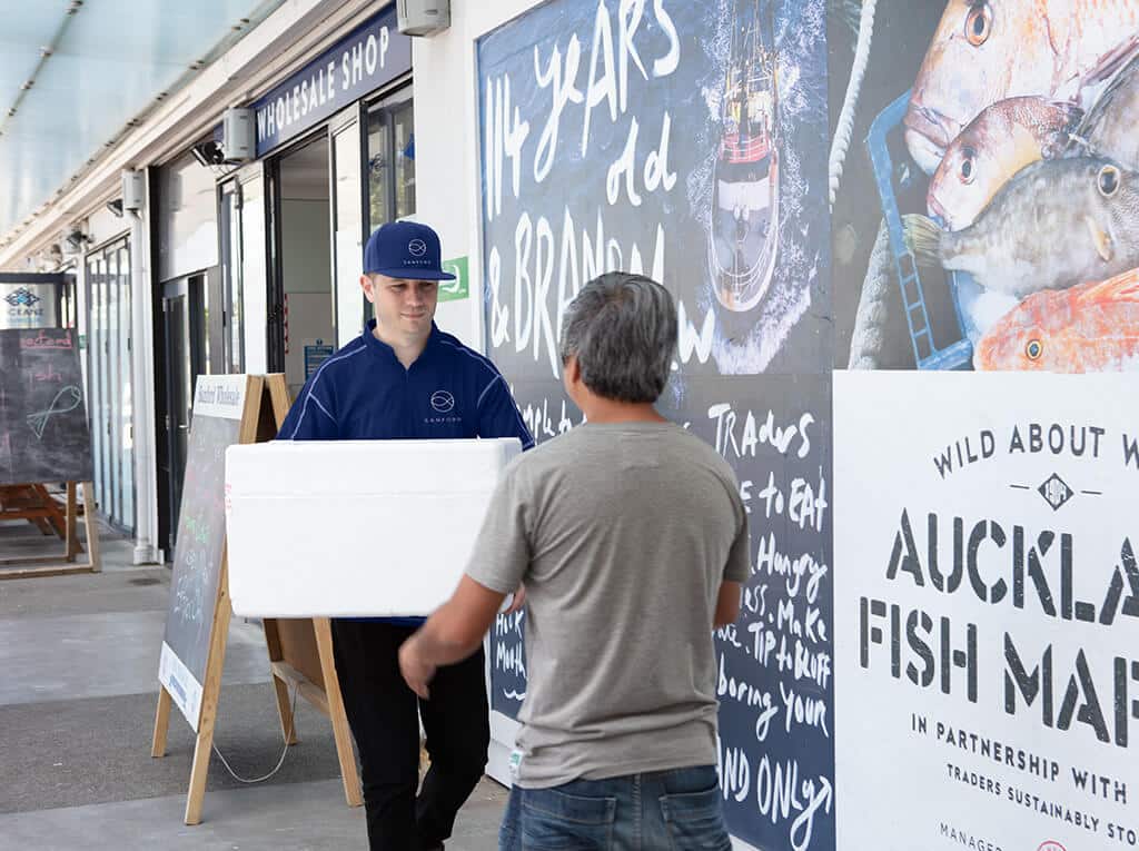 Kiwi-Express-Sanford-Auckland-Fish-Market-delivery Kiwi Express Courier driver in Sanford uniform delivers fresh fish.